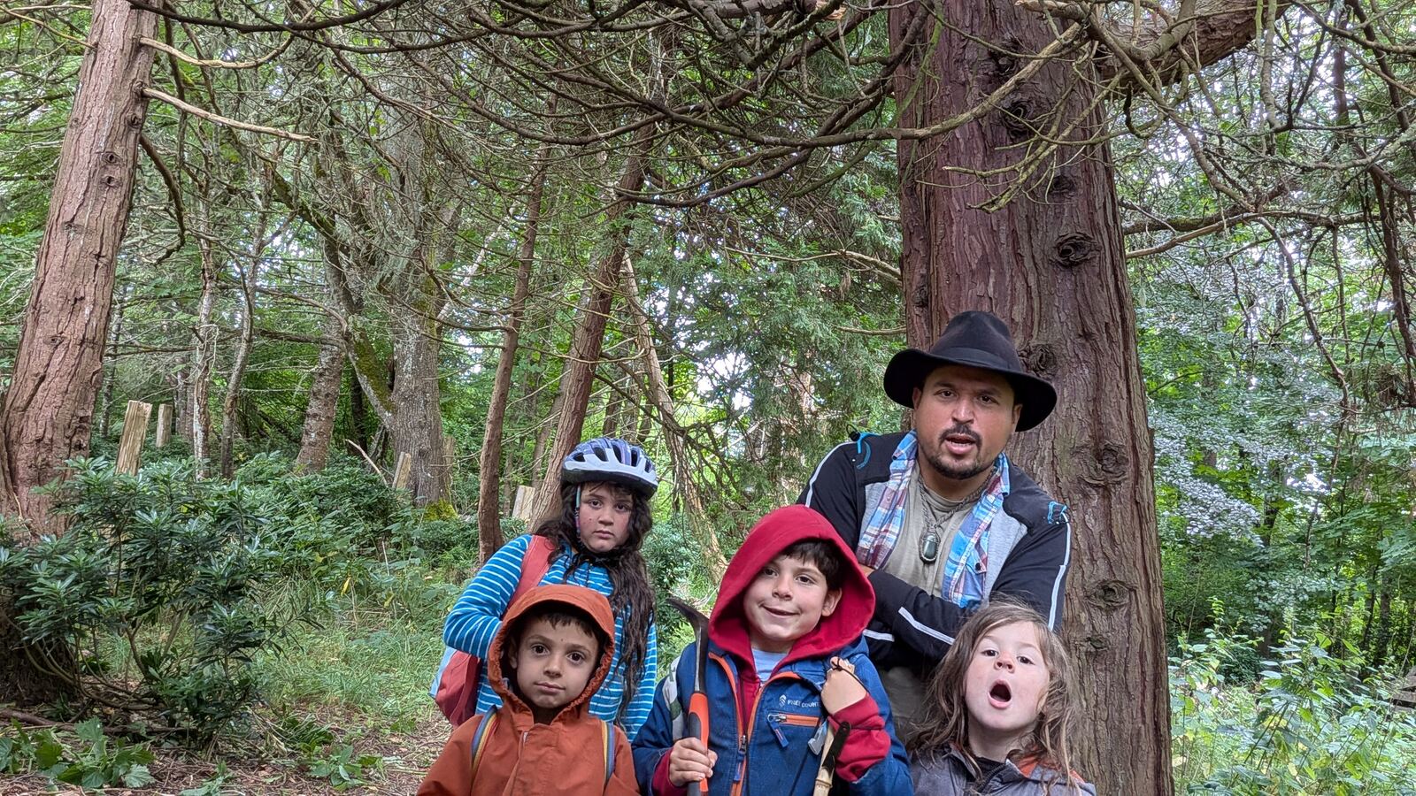 A mentor with a group of children in the forest
